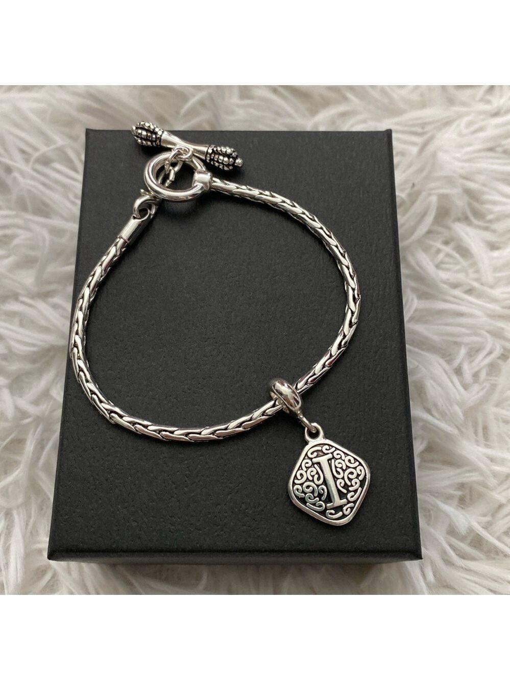 Silver woven bracelet with “i” charm